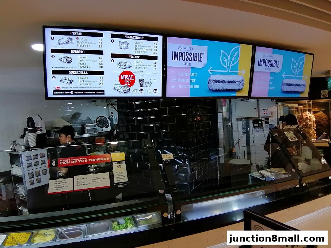 Digital menus display Kebab, Burrito, Quesadilla, Daily Bowl, and Tacos options at Stuff'd.