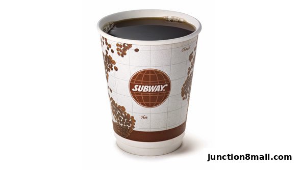 A cup of hot coffee with the Subway logo and coffee bean design.