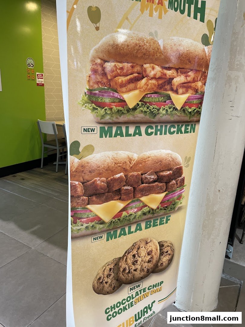 A Subway promotional poster featuring Mala Chicken, Mala Beef sandwiches, and chocolate chip cookies.