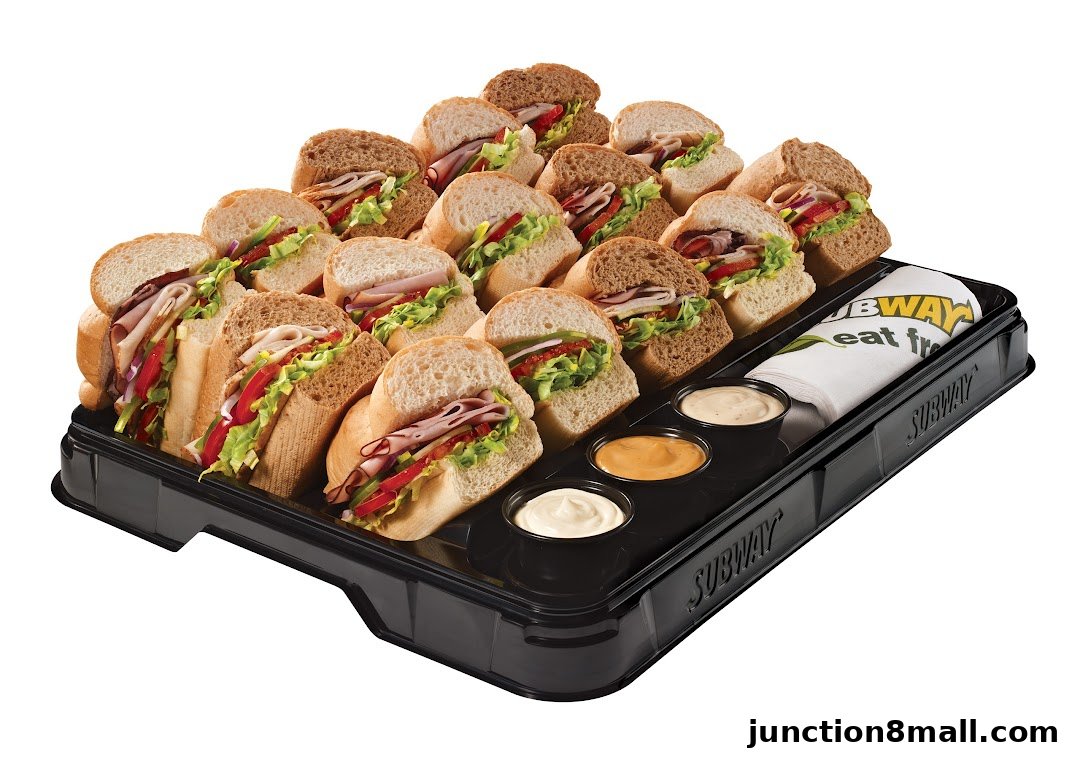 A platter of assorted Subway sandwiches and dipping sauces.