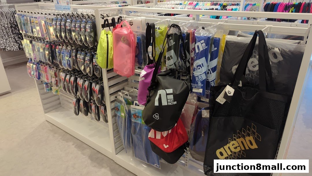 A retail display showcasing various swimming accessories like bags, goggles, and caps.