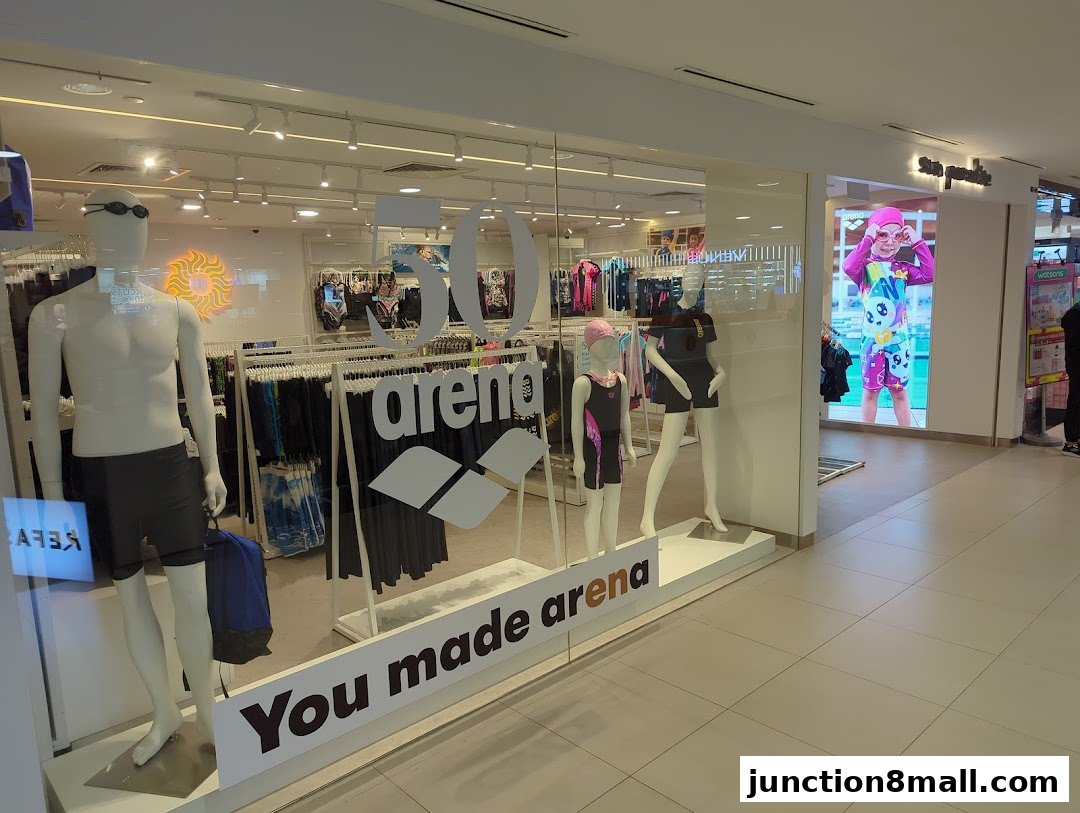 Sun Paradise shop front with mannequins displaying swimwear and the Arena logo.