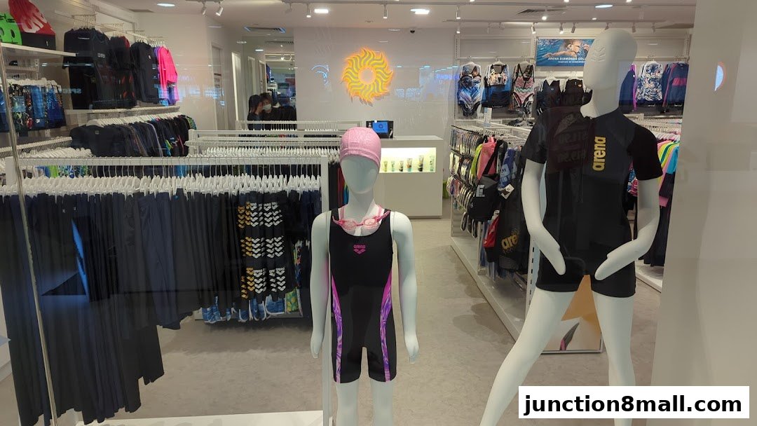 Mannequins display swimwear and accessories in a brightly lit retail store.