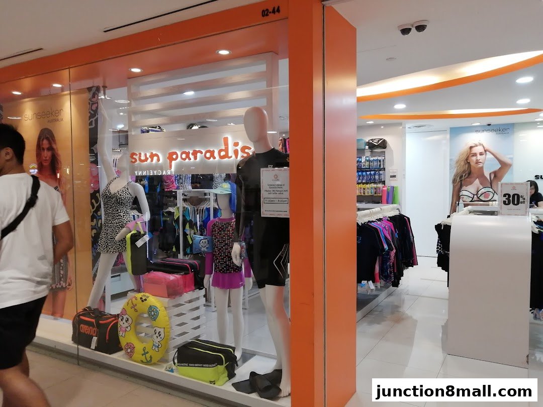 Sun Paradise shop front displays swimwear and accessories on mannequins and racks.