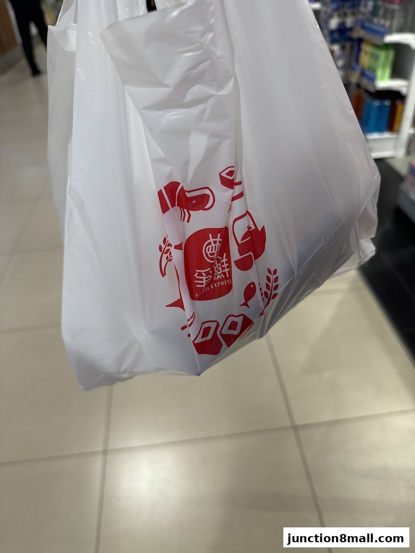 A white plastic shopping bag with the SUSHI EXPRESS logo and sushi graphics.
