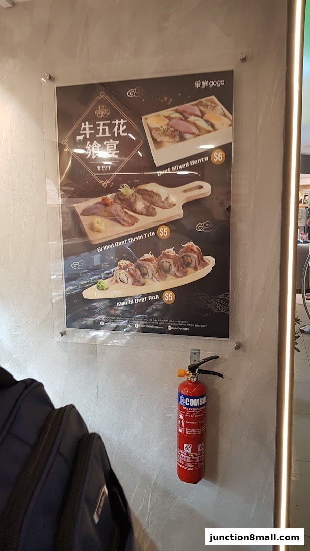 A menu board showcasing beef sushi dishes and a bento box from Sushi Gogo.