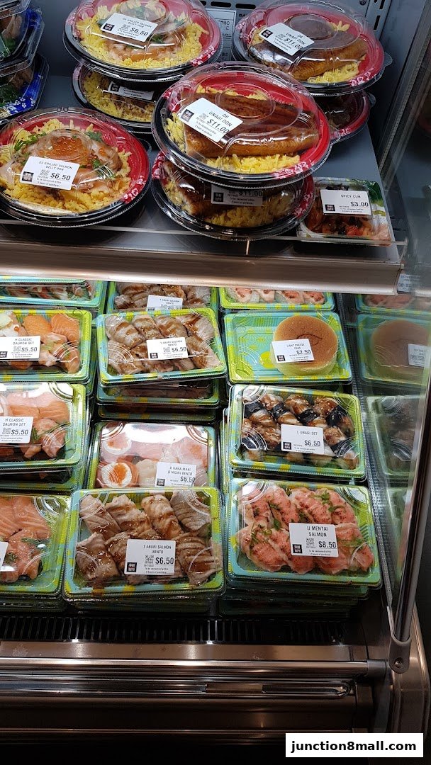 A display of various pre-packaged sushi and bento boxes with prices.