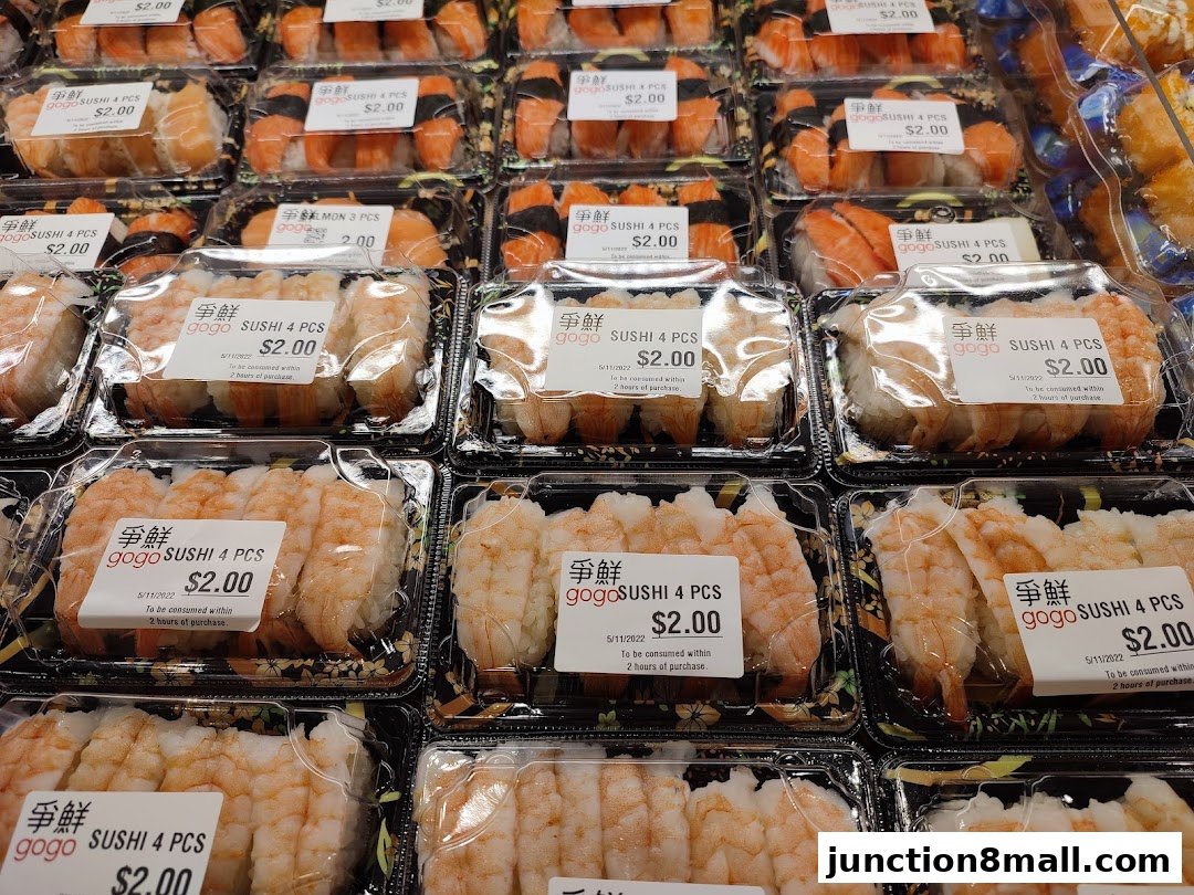 A display of pre-packaged sushi sets, primarily featuring shrimp and salmon, with clear pricing.