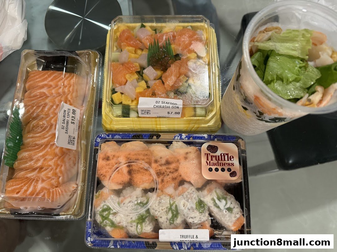 A selection of sushi and sashimi takeout containers, including salmon sashimi, chirashi don, and truffle-themed sushi rolls.