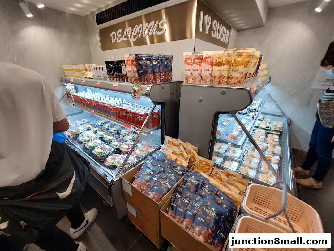 A display of pre-packaged sushi, salads, drinks, and snacks at a SUSHI GOGO store.