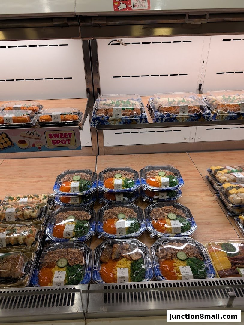 A display of pre-packaged sushi and bento boxes in a refrigerated retail case.