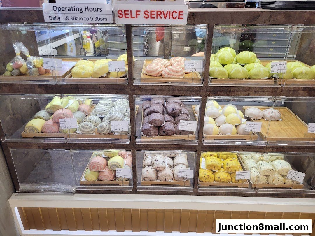 A display of colorful steamed buns and pastries in a self-service shop.
