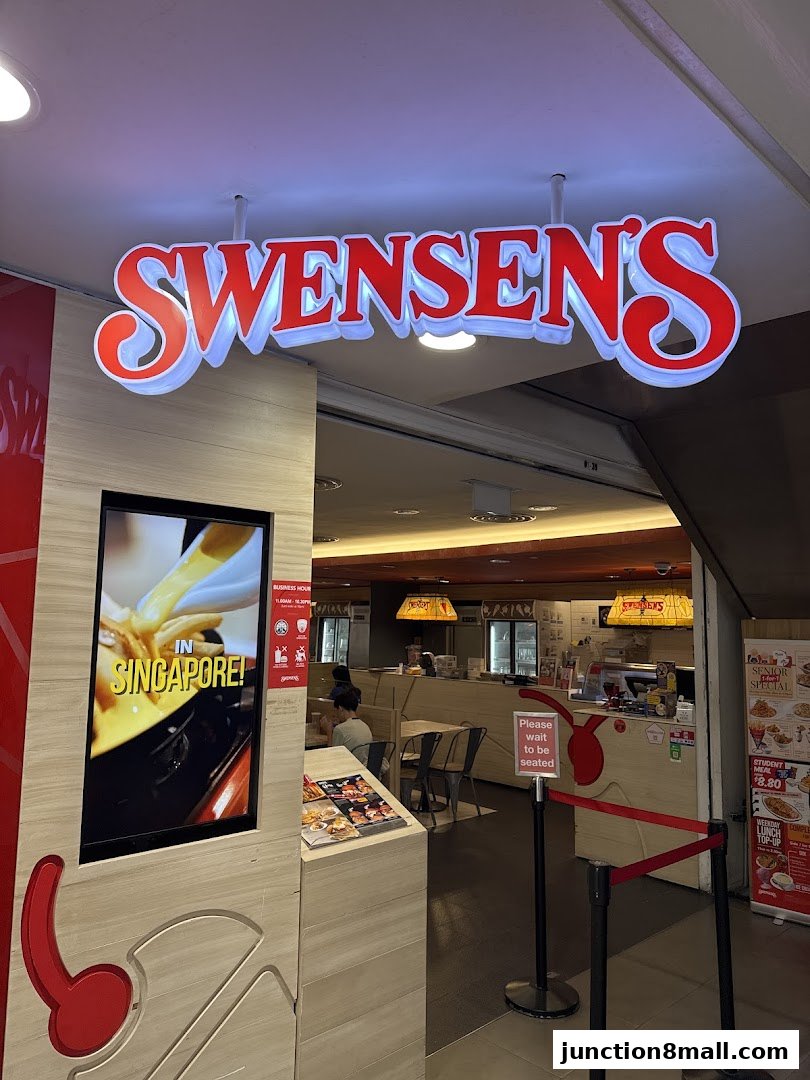 The entrance to Swensen's Junction 8, featuring a prominent sign and a digital display.