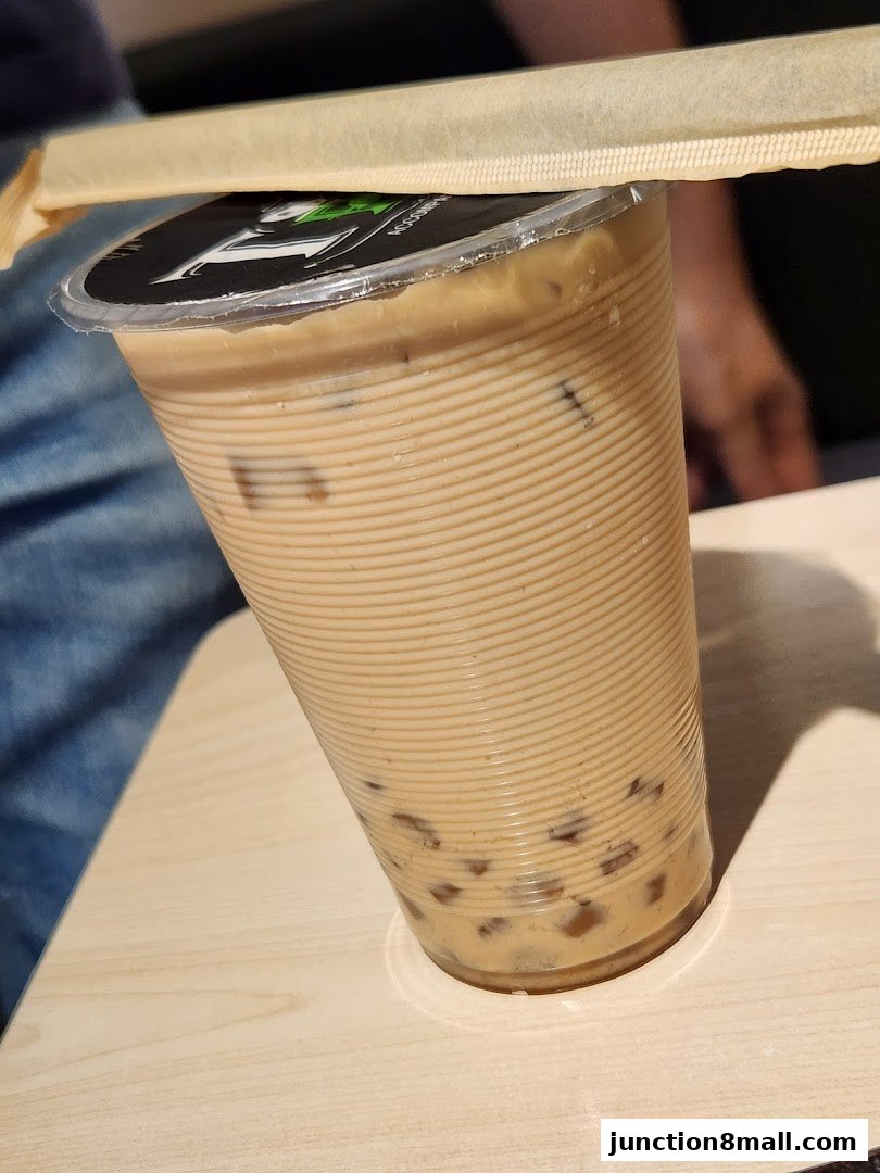 A close-up of a Taiwanese bubble tea with ice and tapioca pearls.