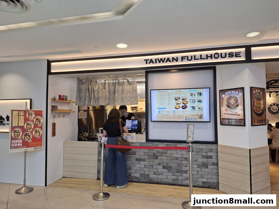 A customer orders at the counter of Taiwan Fullhouse, with a digital menu displayed.