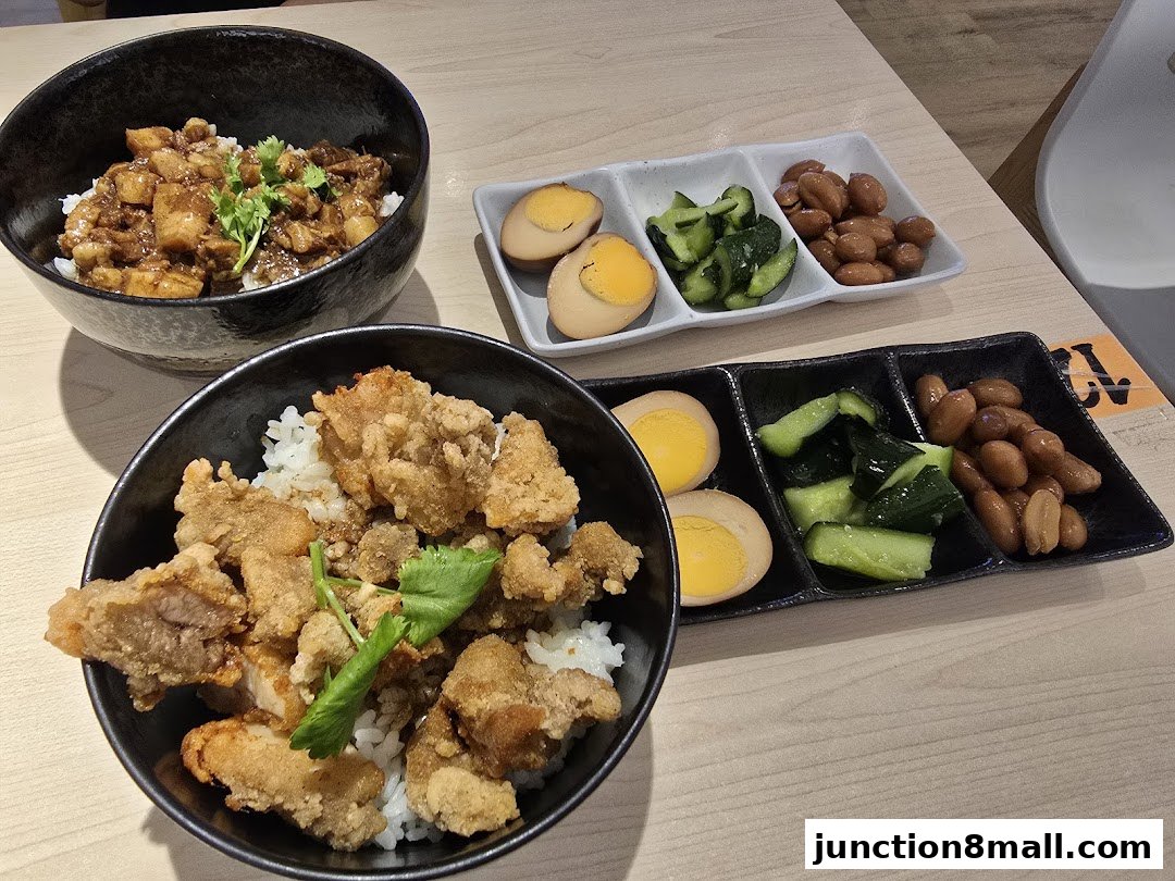 Two bowls of Taiwanese rice dishes with braised pork and fried chicken, served with side dishes.