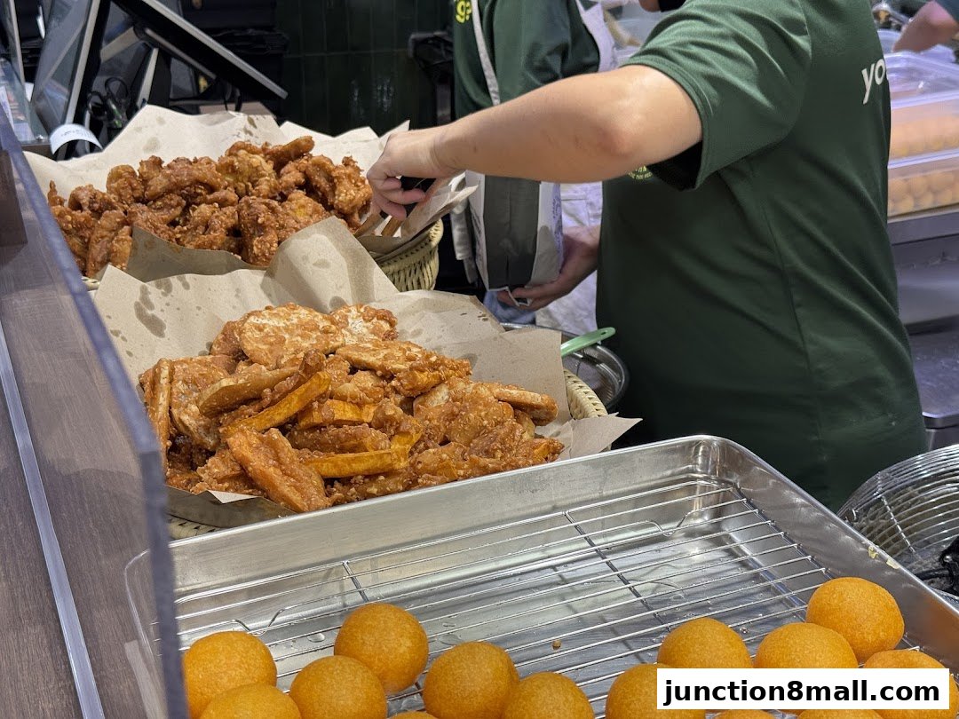 A display of freshly fried snacks, including sweet potato fries and fried bananas.