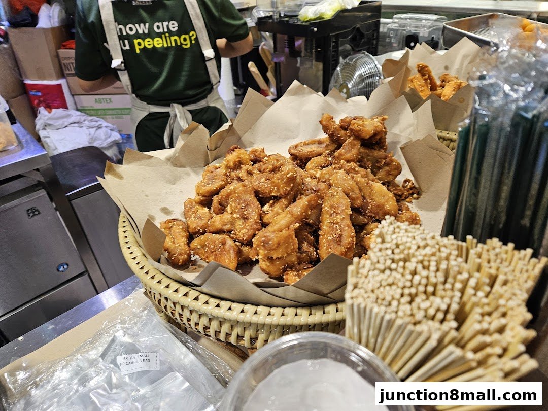 A basket of crispy fried bananas with sesame seeds, ready to be served.