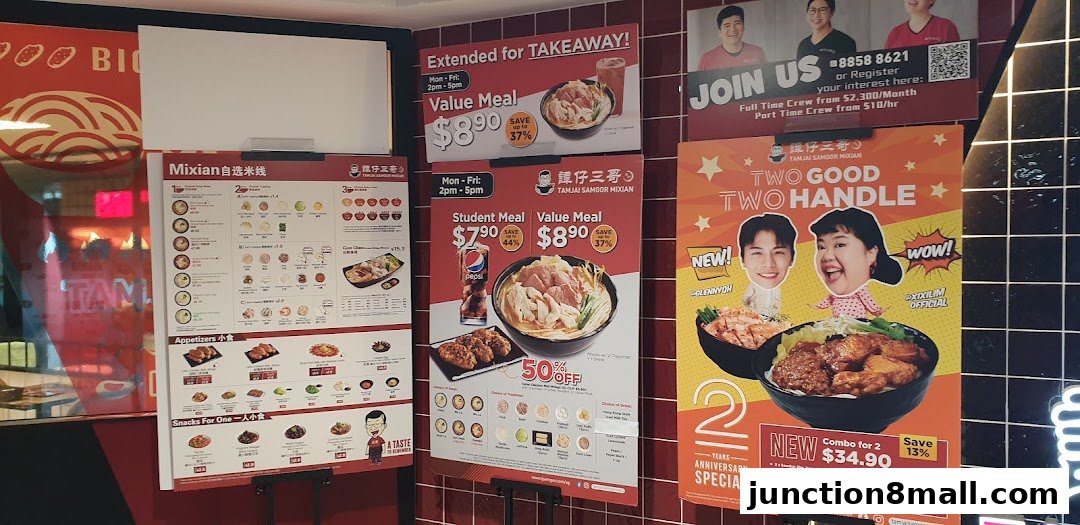 A wall display featuring menus and promotions for TamJai SamGor Mixian.