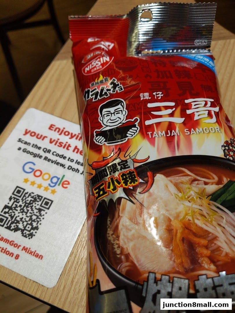A package of TamJai SamGor Mixian noodles with a Google review card.