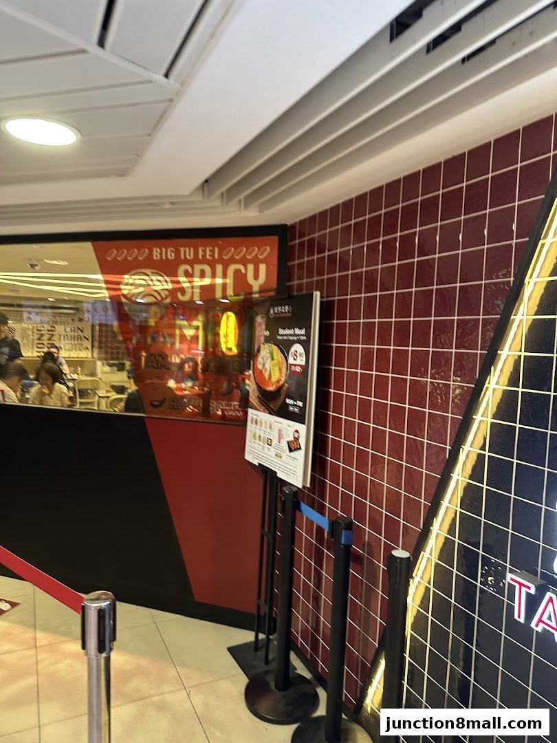 A sign for a student meal is displayed outside a restaurant with red tiled walls.