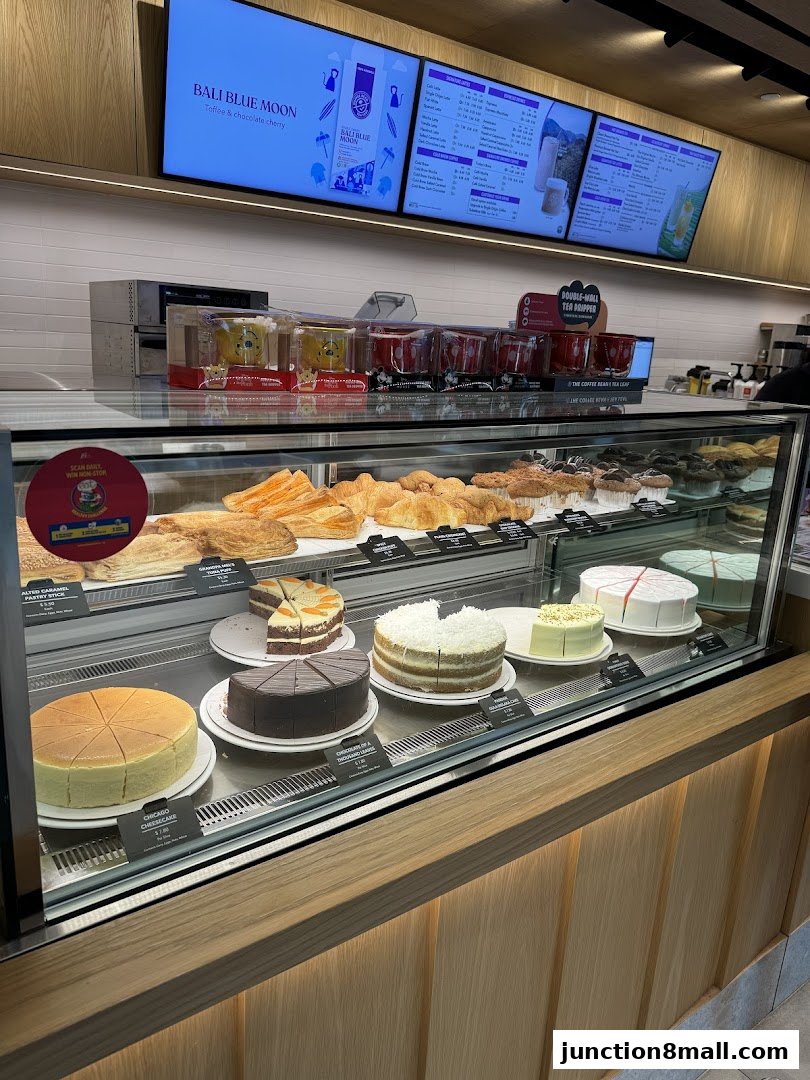 A display case filled with various cakes and pastries at The Coffee Bean and Tea Leaf.