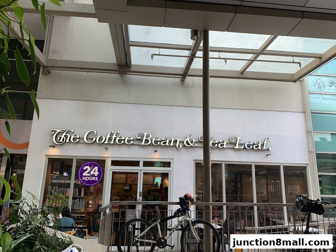 The exterior of The Coffee Bean & Tea Leaf shop, featuring its prominent signage and a 24-hour notice.