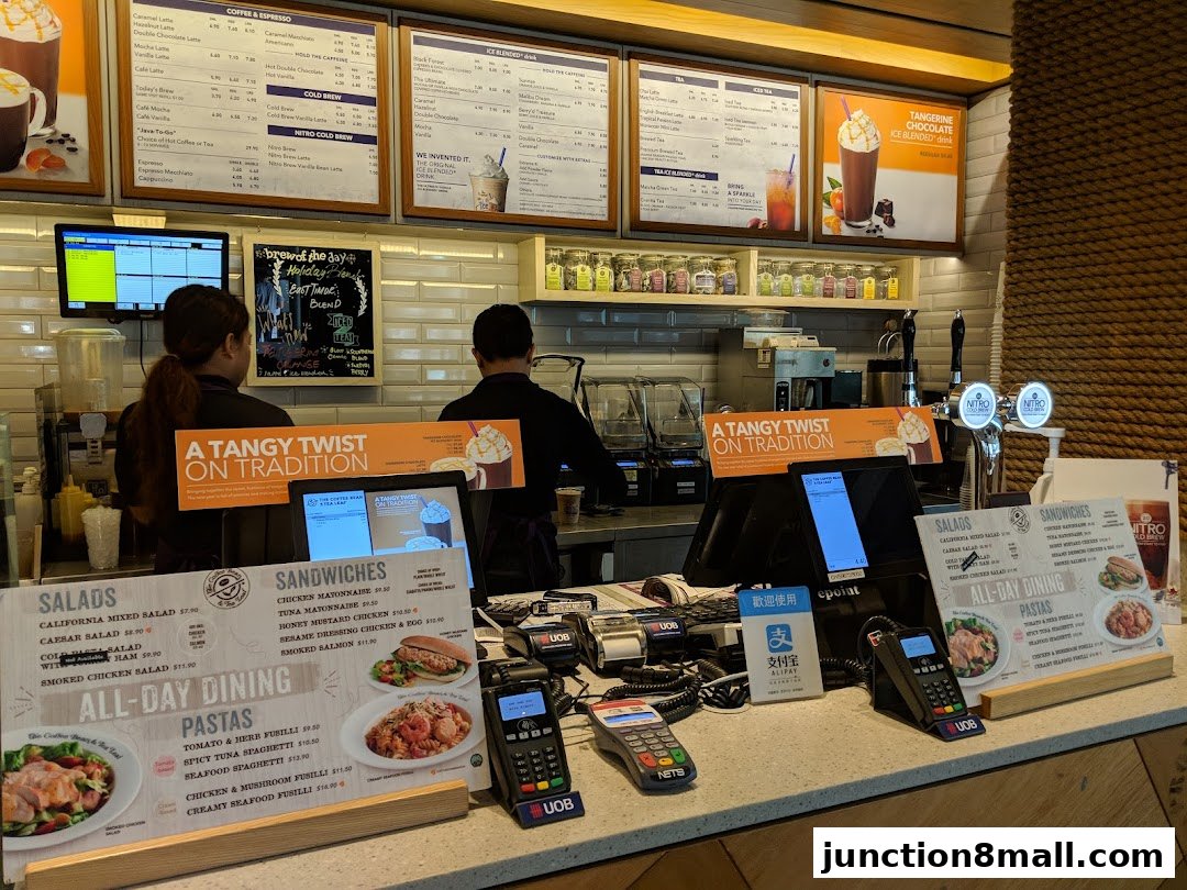A counter display at The Coffee Bean and Tea Leaf with menus for salads, sandwiches, and pastas.