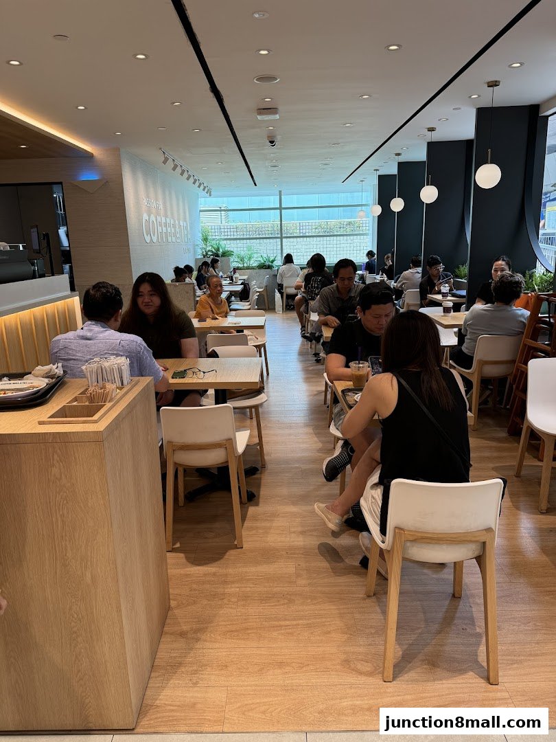 Interior view of The Coffee Bean and Tea Leaf with customers seated at tables.