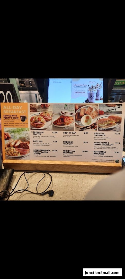 A menu board displaying various breakfast items with prices and images.