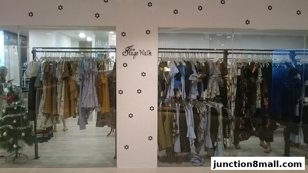 The Stage Walk clothing store entrance with racks of dresses and apparel visible.