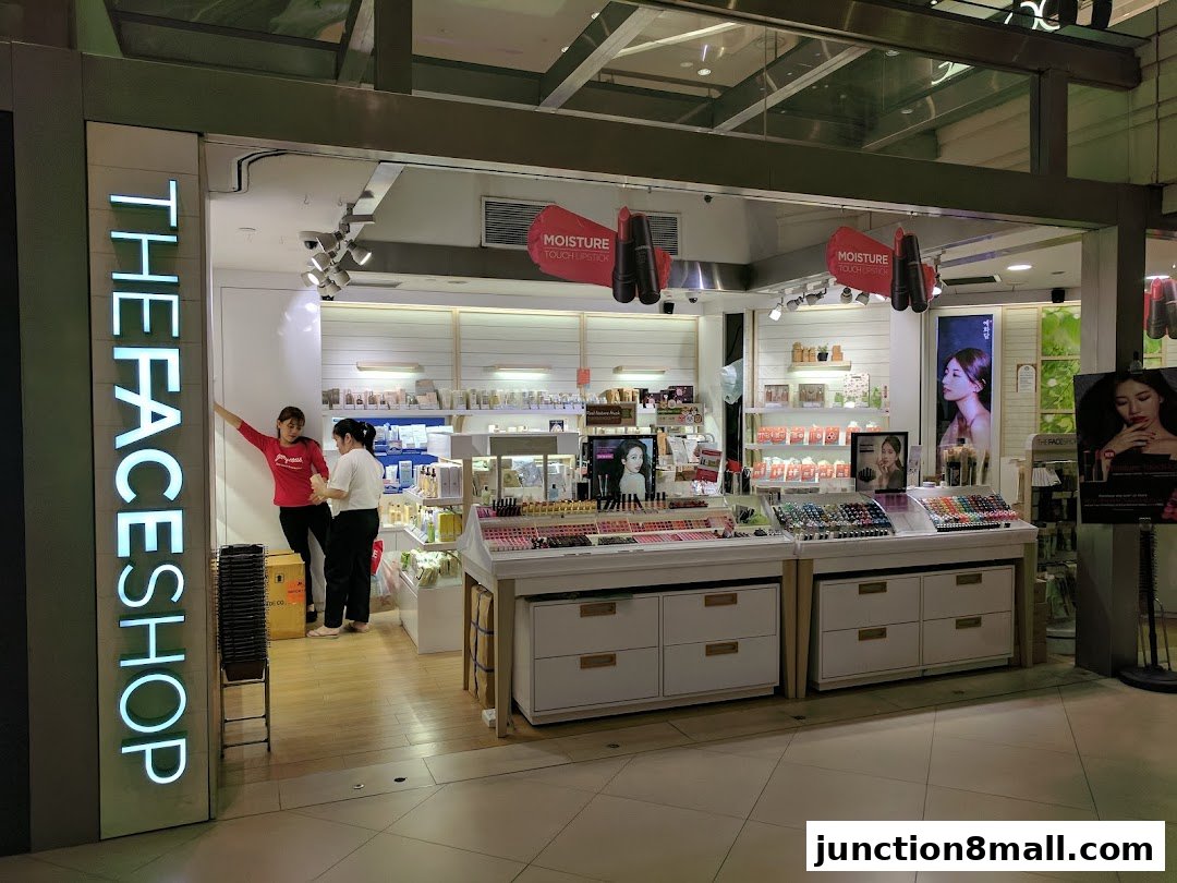 The Face Shop store entrance with makeup displays and staff.
