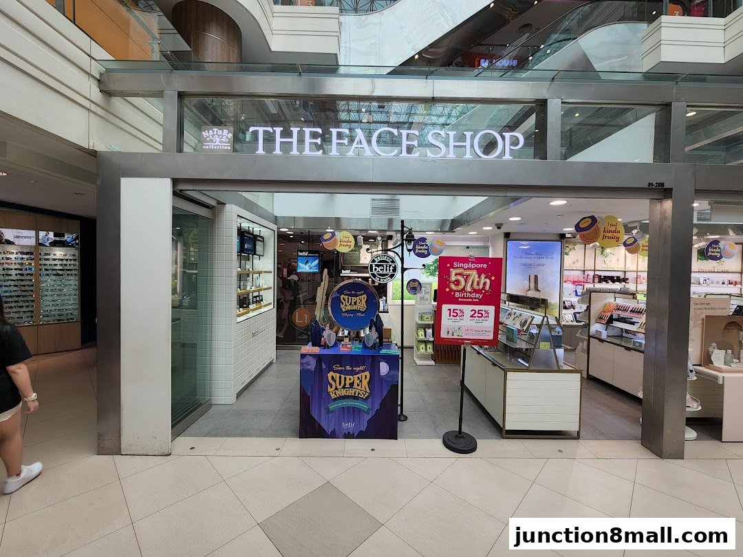 The entrance of THE FACE SHOP, a beauty store, with promotional displays and products visible inside.