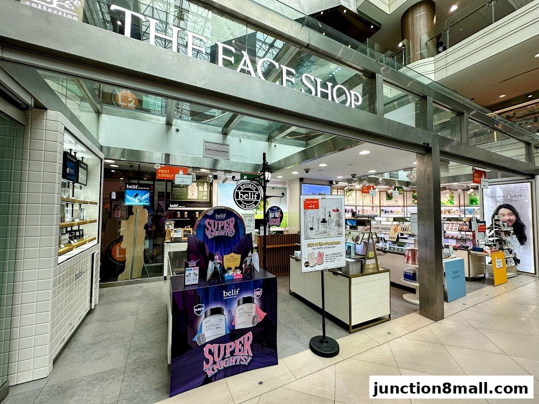 The entrance of THEFACESHOP, a beauty store, showcasing various skincare products and promotions.