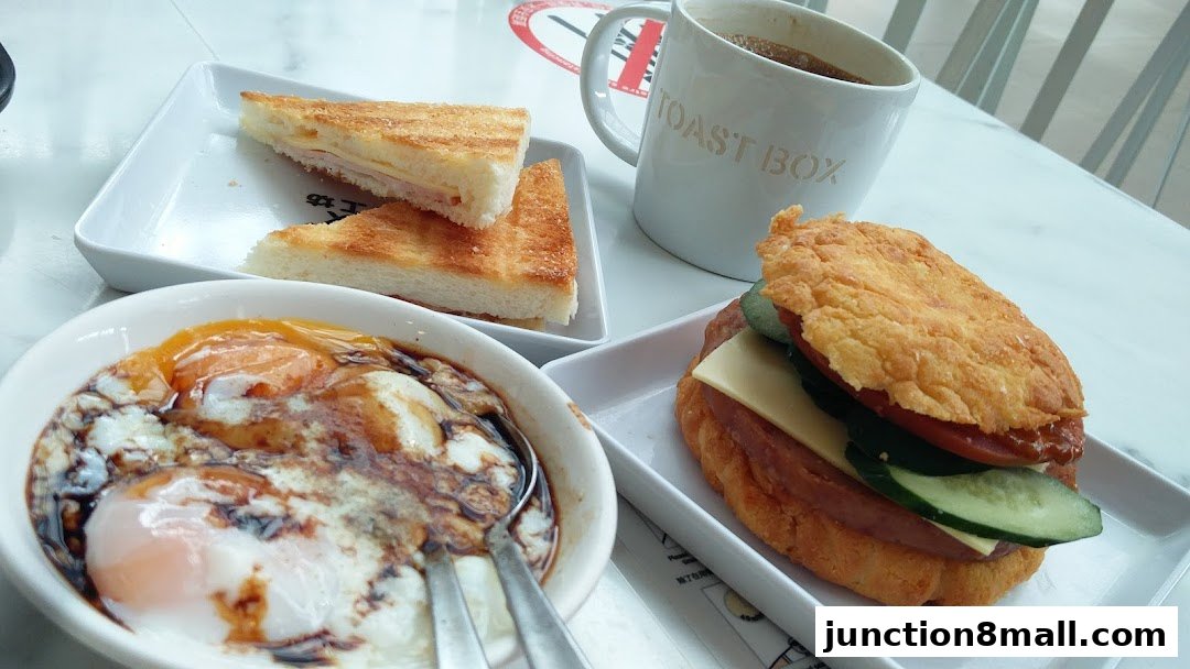 A delicious breakfast spread featuring soft-boiled eggs, toast, and a sandwich with coffee.