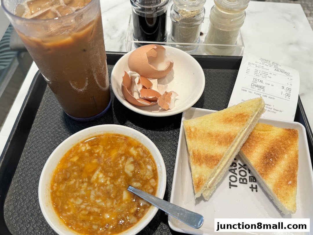 A tray with a drink, toast, soft-boiled eggs, and a receipt from Toast Box.