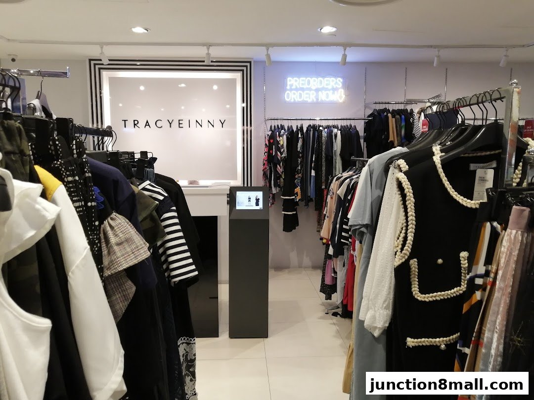 Interior view of a clothing store with racks of apparel and the store's logo.