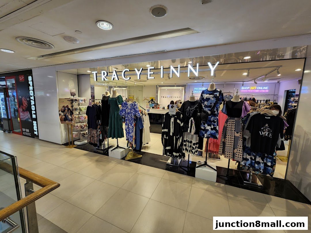 A fashion boutique named Tracyeinny displays various stylish dresses and outfits on mannequins.