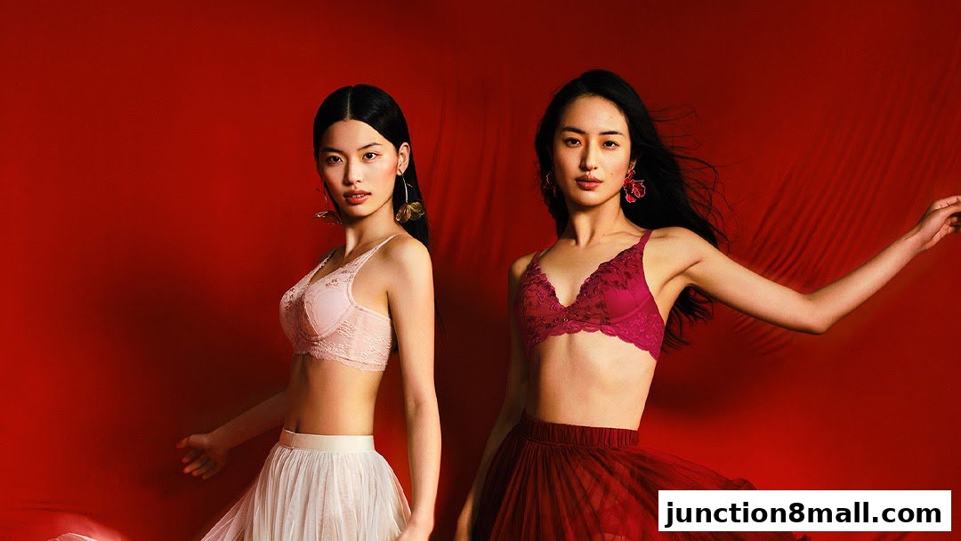 Two models showcase lace bras and flowing skirts against a vibrant red background.