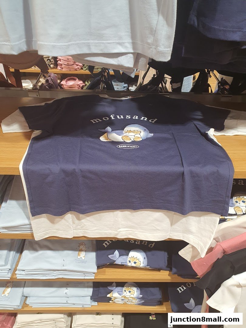 Shelves filled with folded t-shirts featuring cute cartoon characters and branding.