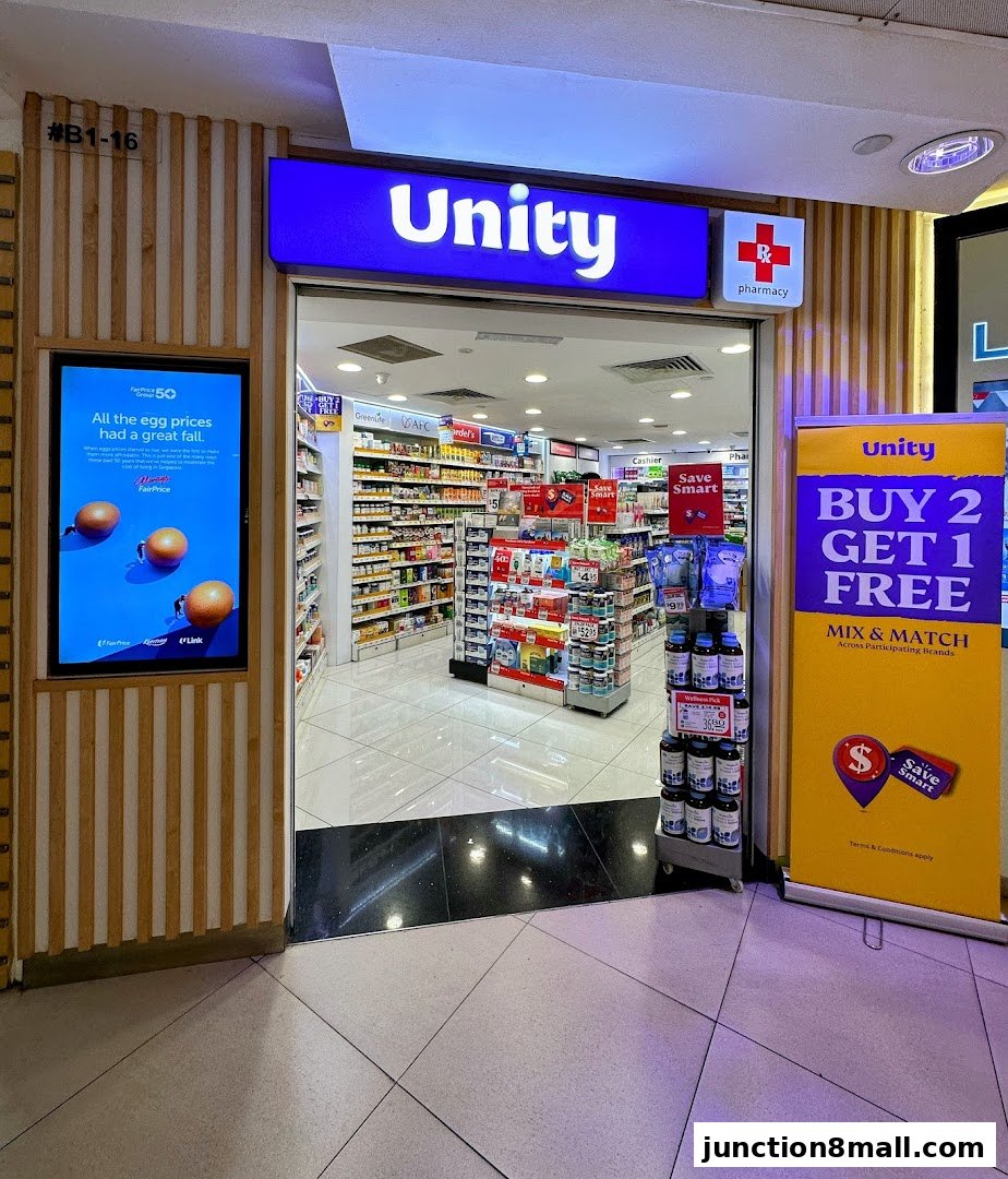 The entrance to Unity Pharmacy, with promotional displays and a digital advertisement.