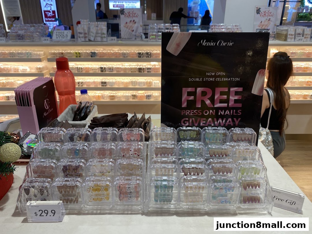 A display of press-on nails and a 'Free Press On Nails Giveaway' sign at Venia Cherie.