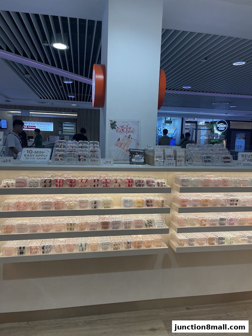 A retail display showcasing various press-on nail sets and beauty products.