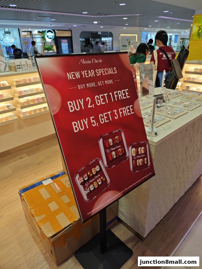 A red sign advertising New Year specials for Venia Cherie with buy more, get more deals.