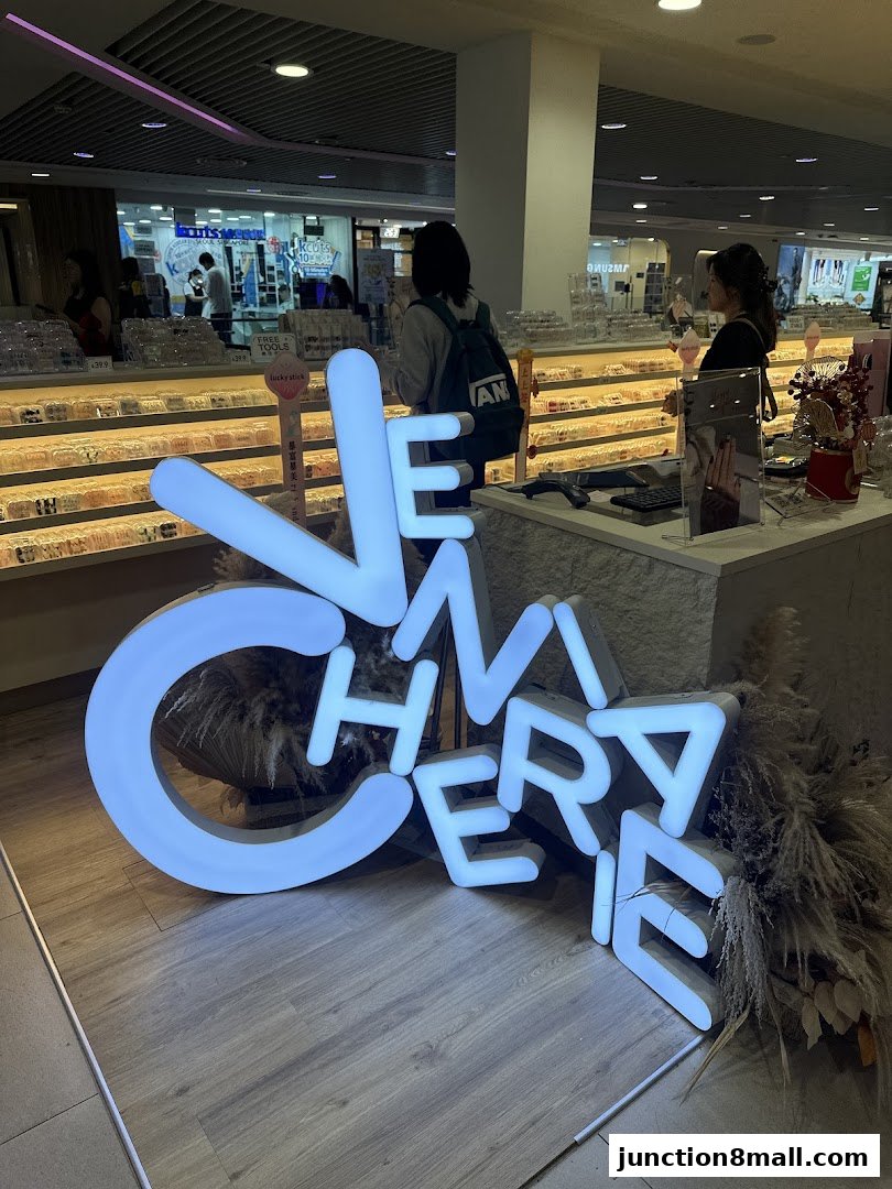 A brightly lit shop interior with a large neon sign spelling 'VeniaCherie'.