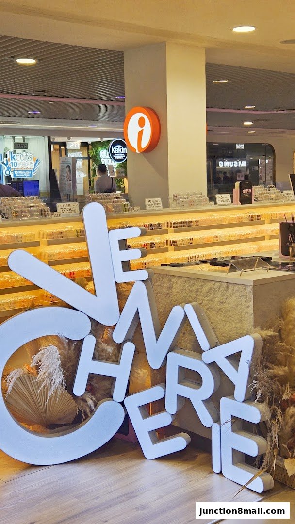 A shop interior with large white letters spelling 'VENIA CHERIE' and displays of products.