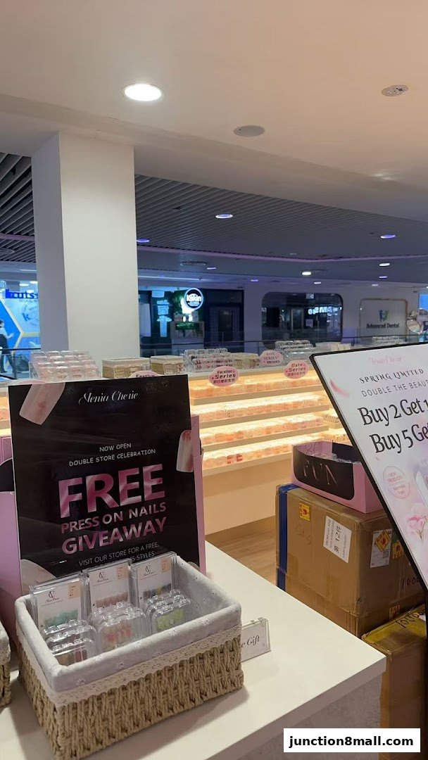 A store display featuring a giveaway for free press-on nails and various nail products.