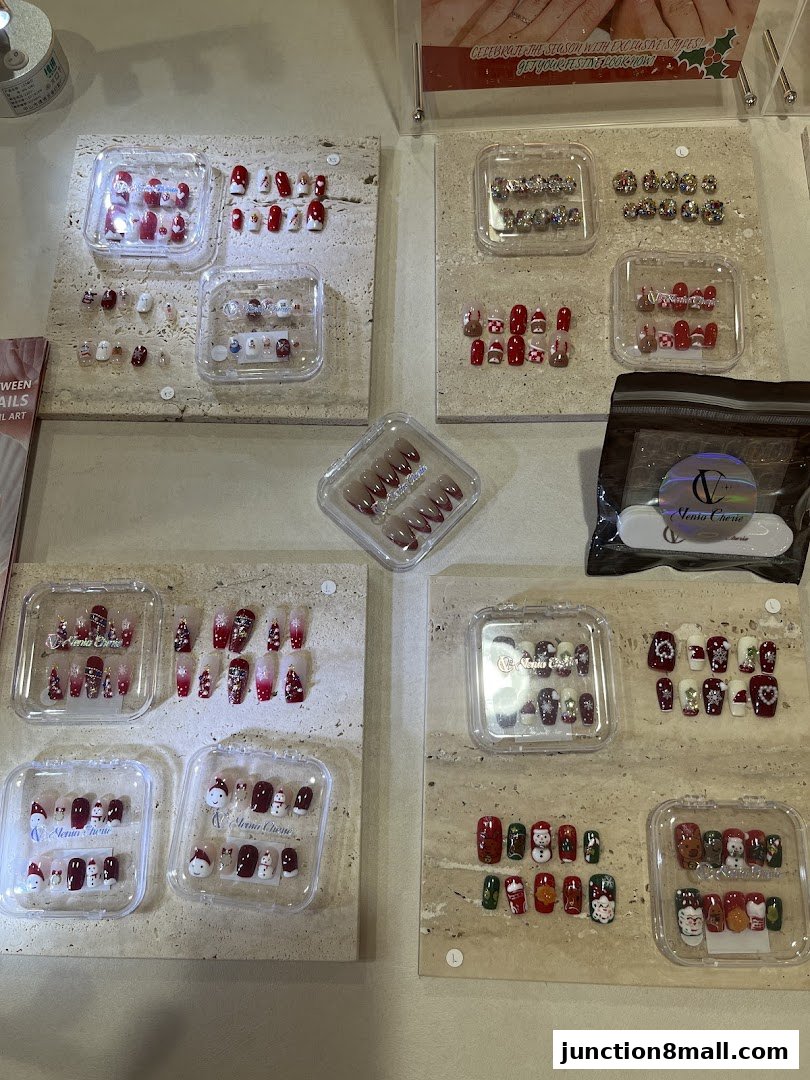 A display of various festive-themed artificial nails, featuring Christmas designs.