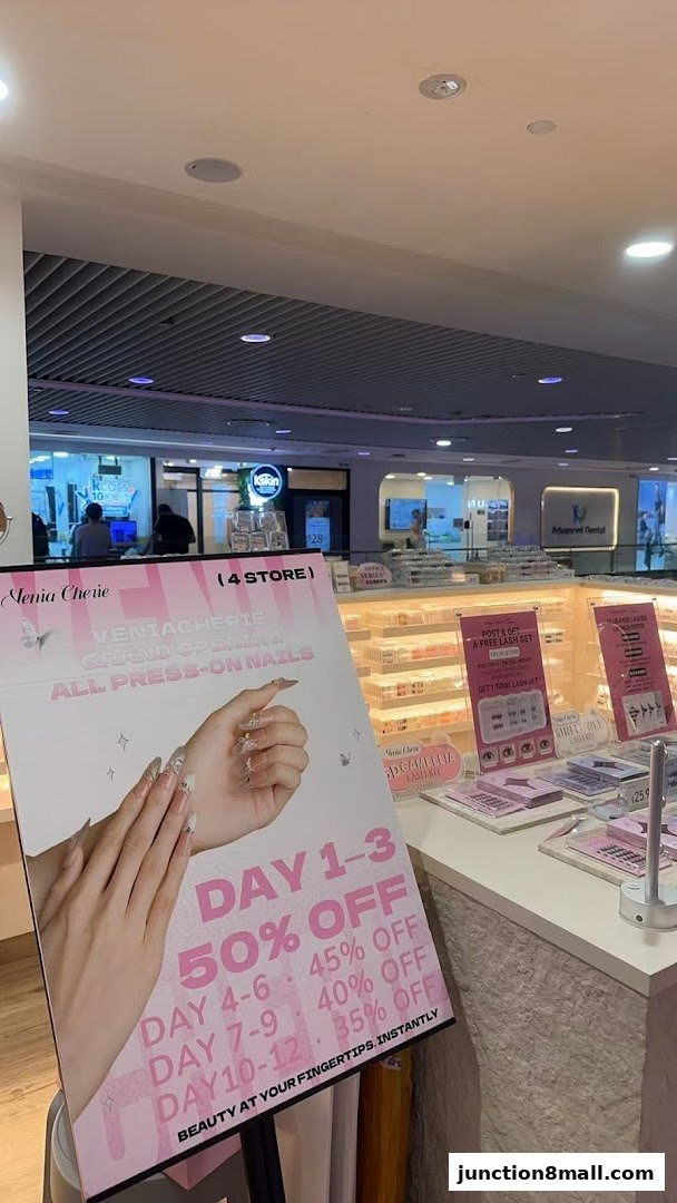 A promotional sign for Venia Cherie's grand opening of press-on nails with tiered discounts.