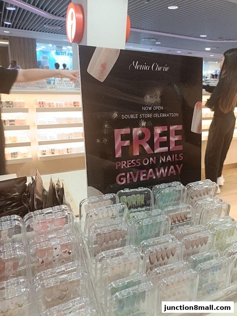 A display of press-on nails with a promotional sign for a giveaway.